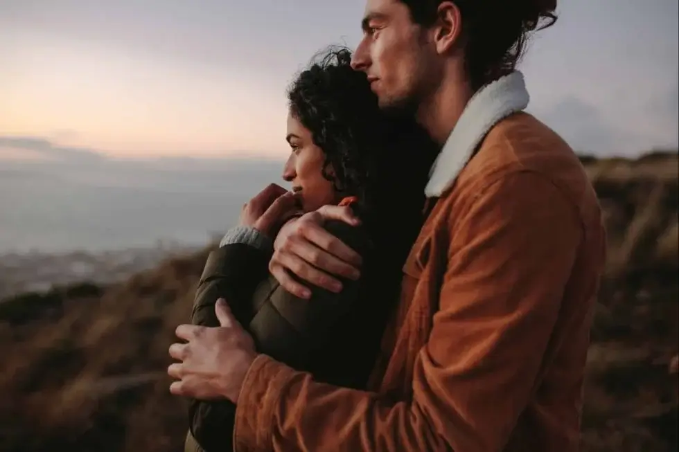 Couple at sunset looking at mountains