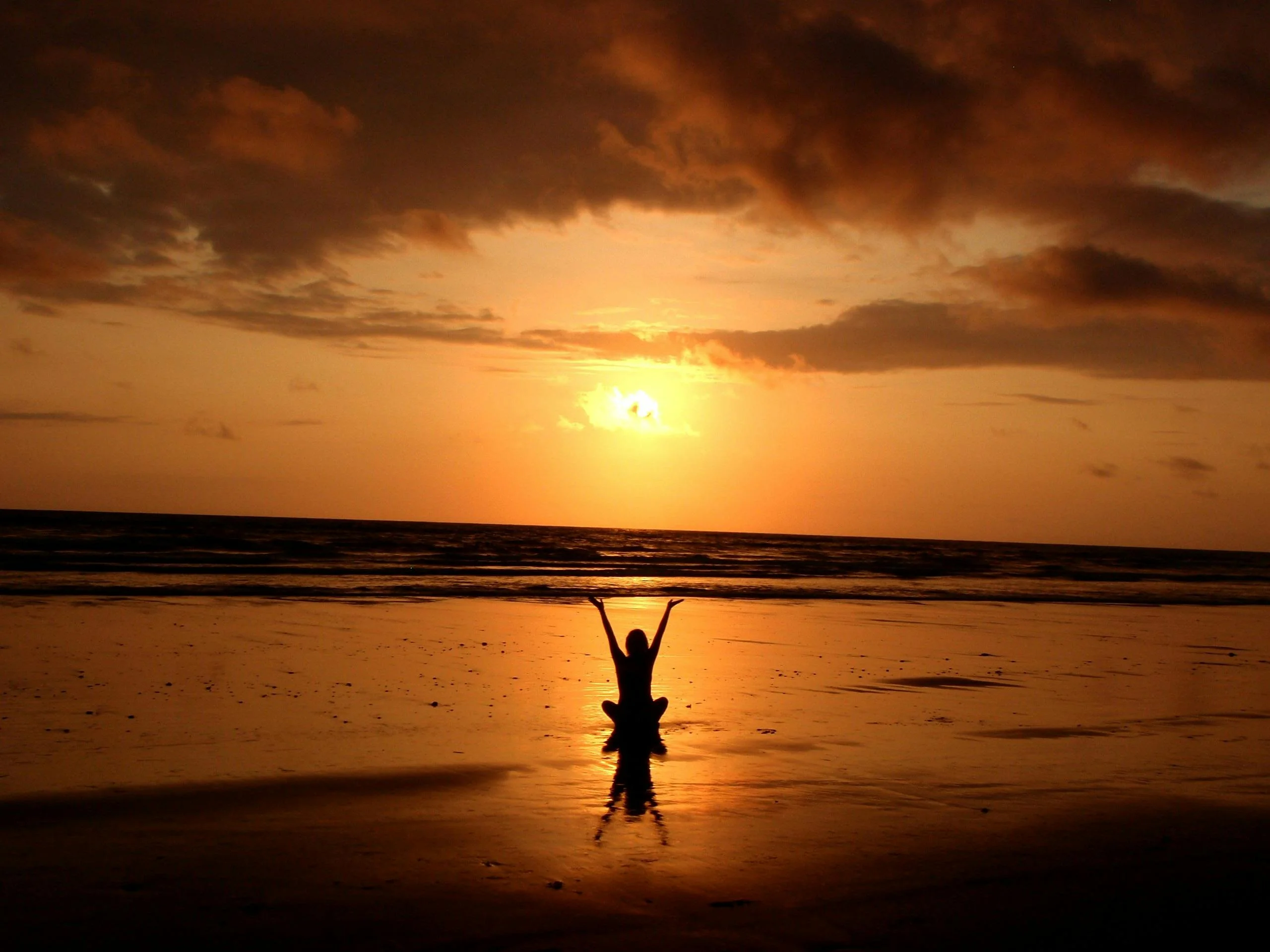 Woman on beach at sunset